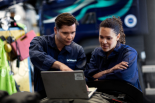 Two  service technicians looking at a laptop 