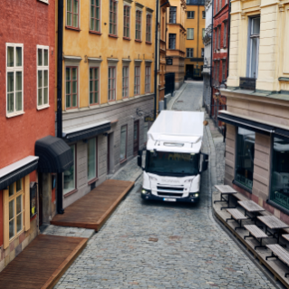 Truck driving in narrow city street