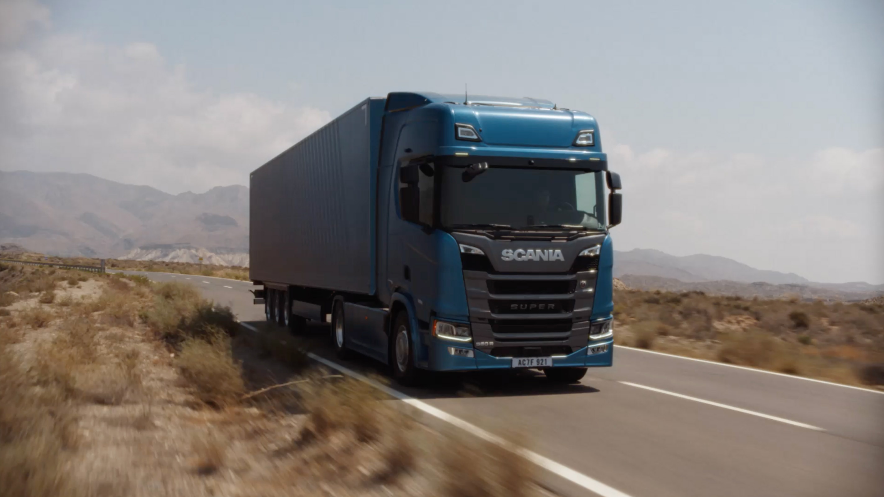 Experience Scania on the road:- Scania Super truck driving through desert terrainScania delivers reliable trucks, buses, and engines for every journey.