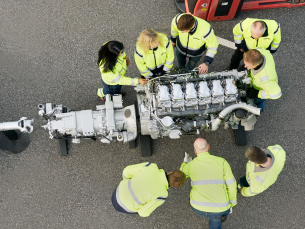 Employees working with an engine