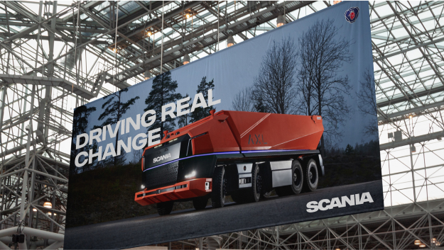 Image with orange vehicle and text Driving real change