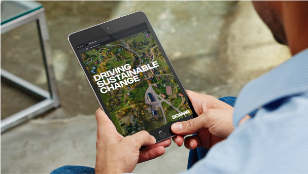 Image of person holding tablet and text Driving sustainable change