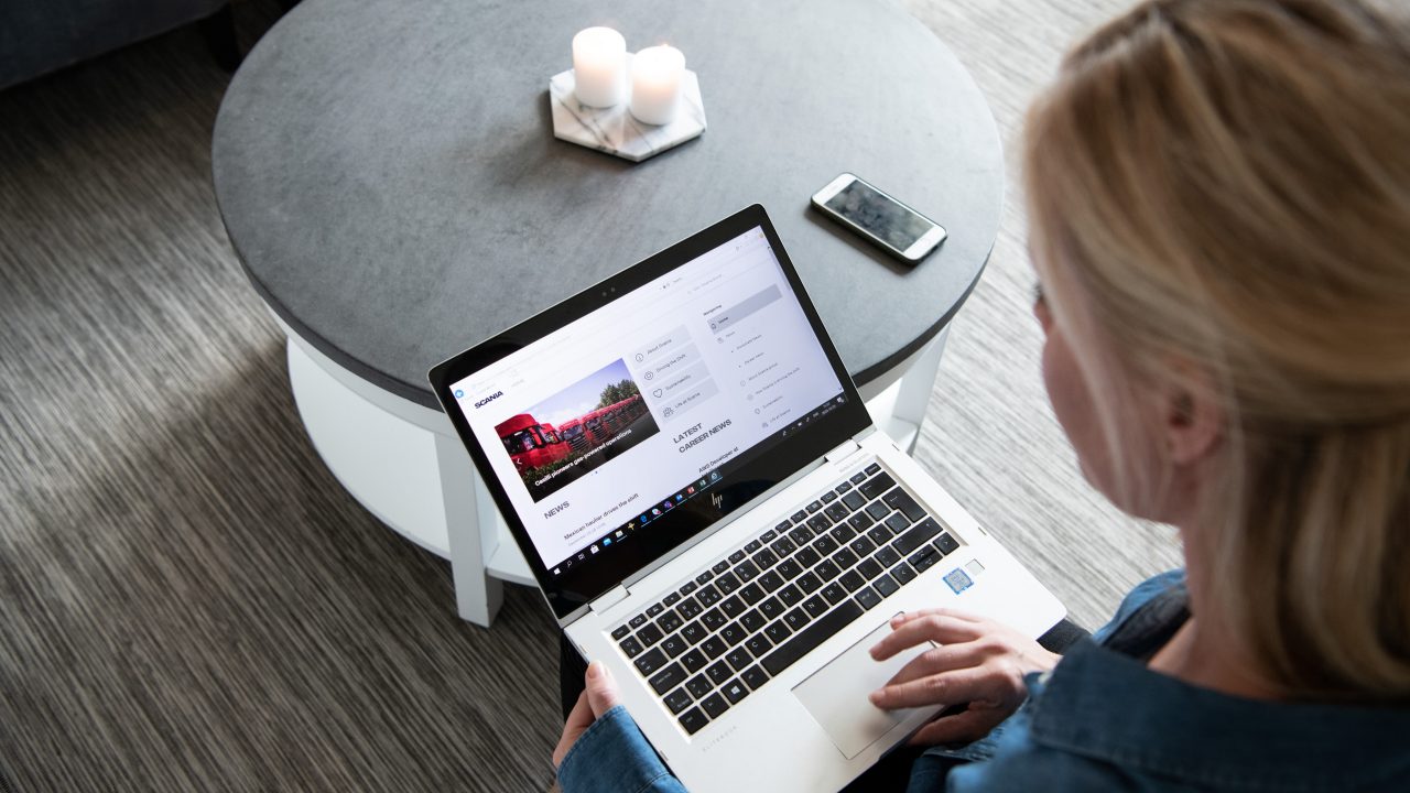 Office staff at home with Scania world application. 